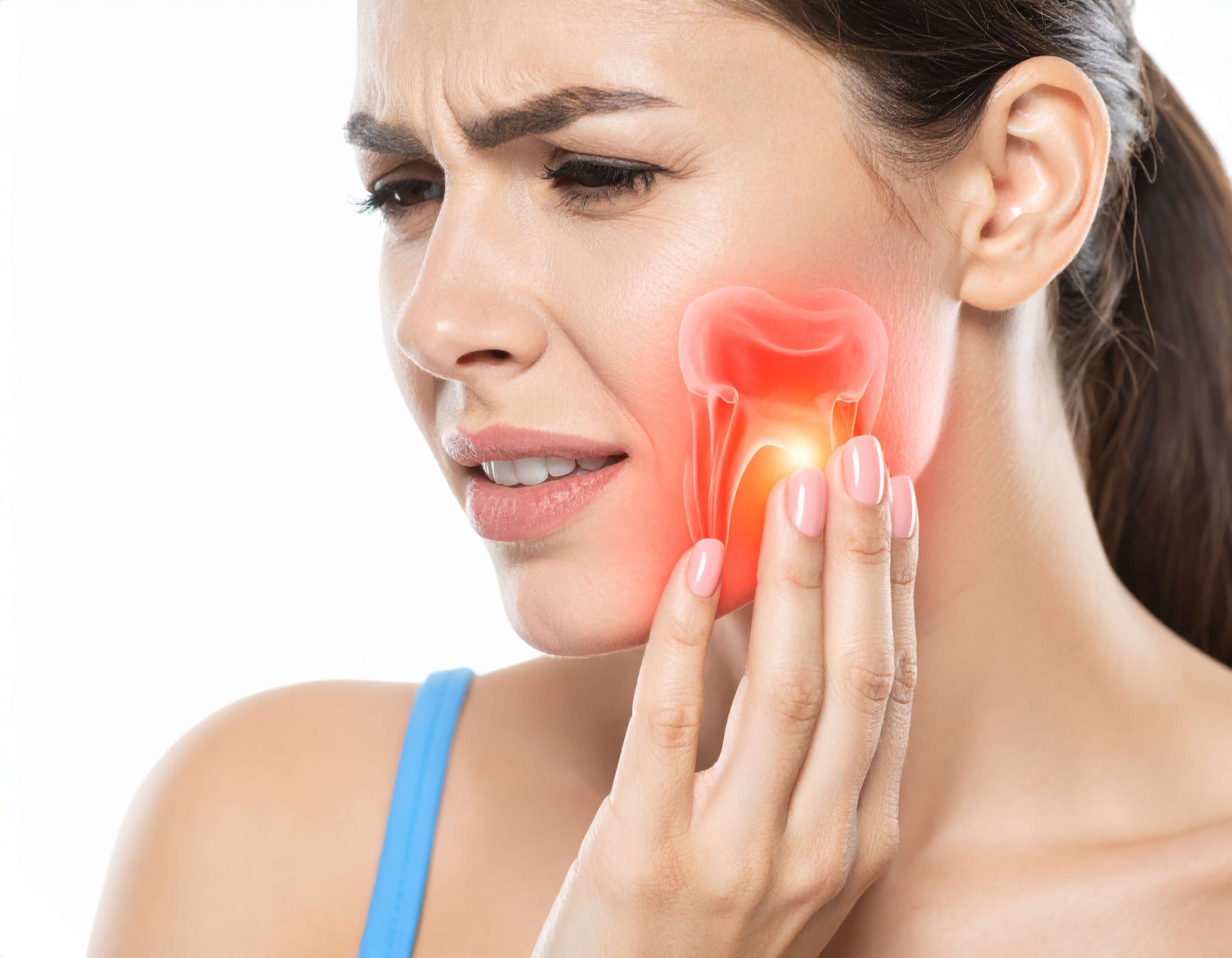 Woman holding her jaw with highlighted tooth pain from a wisdom tooth concern